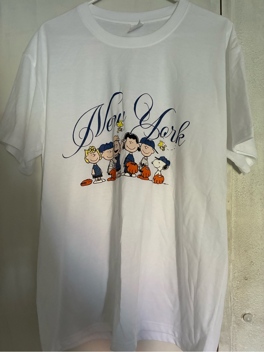 SHEIN White Graphic Tee with Peanuts Characters and 'New York' Script